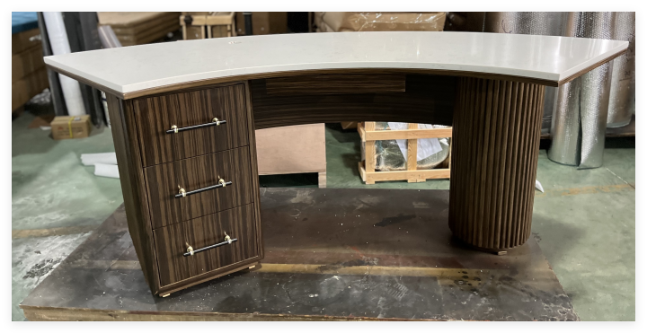 a bespoke reception desk crafted for Intercontinental hotels, featuring a curved design with a white countertop and elegant wooden cabinetry