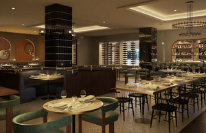 the elegant ambiance of an Intercontinental hotel's dining area, featuring sophisticated lighting, plush seating, and a well-stocked bar.jpg