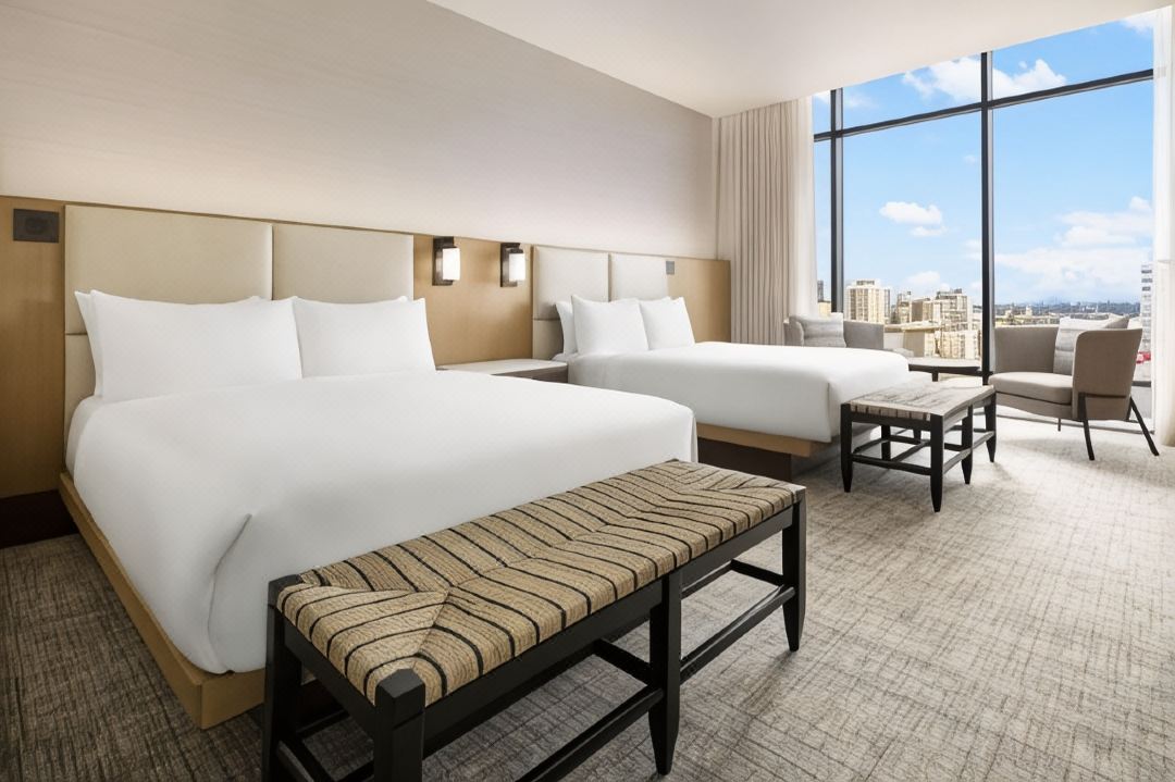 high-end hotel suite furnished according to Hilton standards, bespoke headboard, custom armchairs