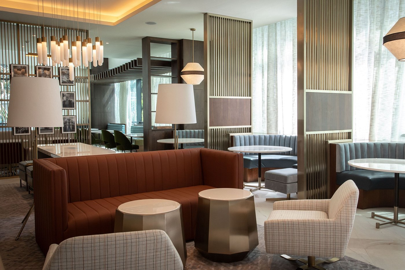 High-back lounge chairs, metal partitions, and booth seating in the lobby lounge area
