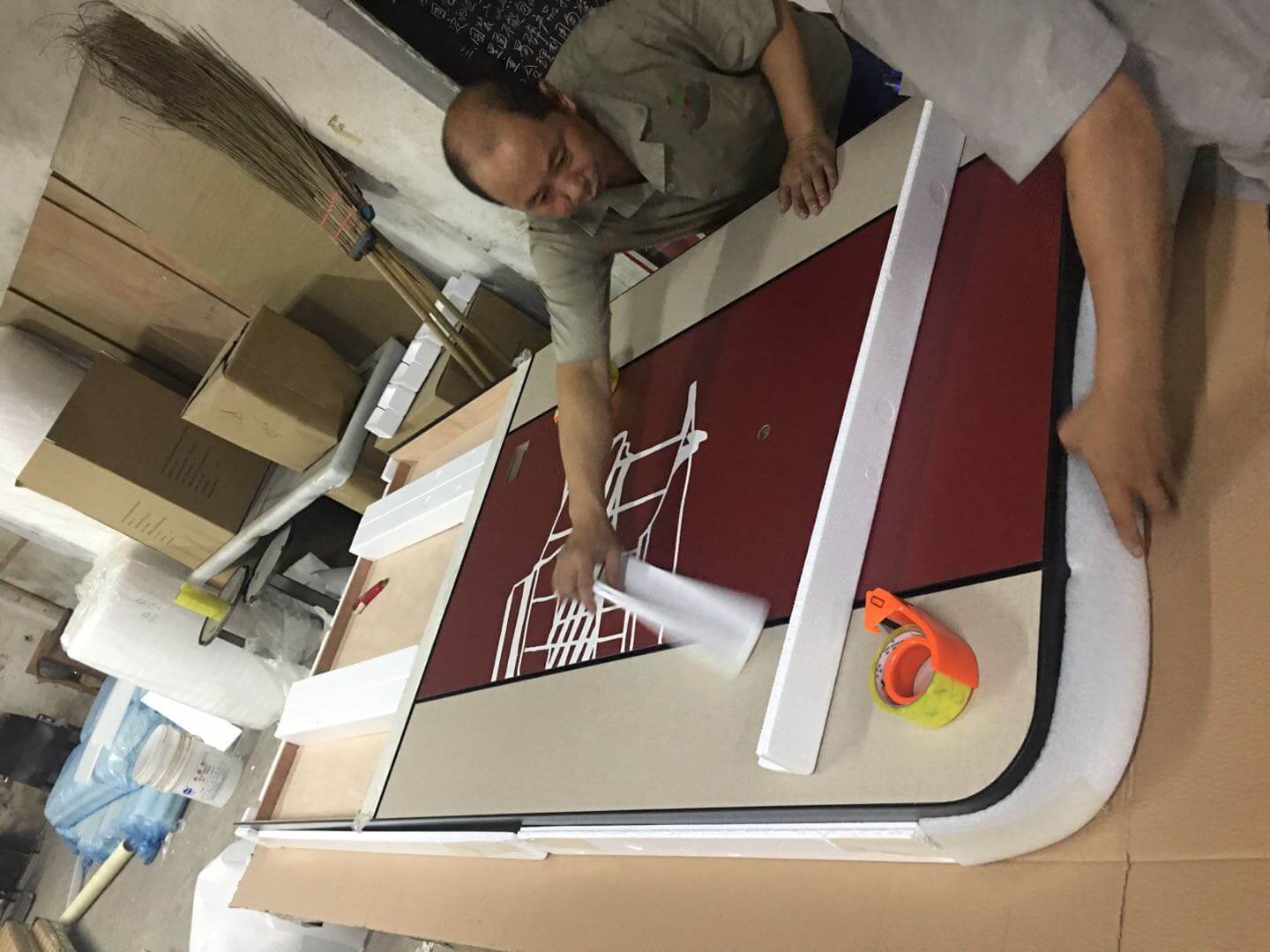 Worker checking headboard artwork panel